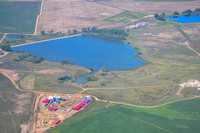 FRACKING APPLICATION SITE - red and purple frac tanks hold water and chemical mixtures. White containers on the left hold chemicals.