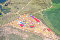 FRACKING APPLICATION SITE - red and purple frac tanks hold water and chemical mixtures. White containers on the left hold chemicals.