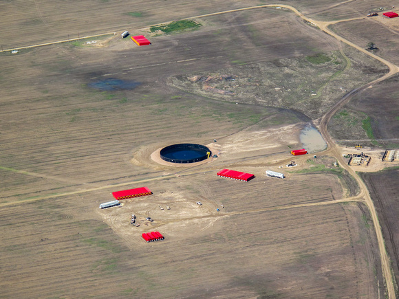 Center: Poseidon Tank (black pool) holds up to 1.7 million gallons of fresh water. Acts as an avove ground storage tank.Red Containers: Frac tanks hold water and or chemical mixtures